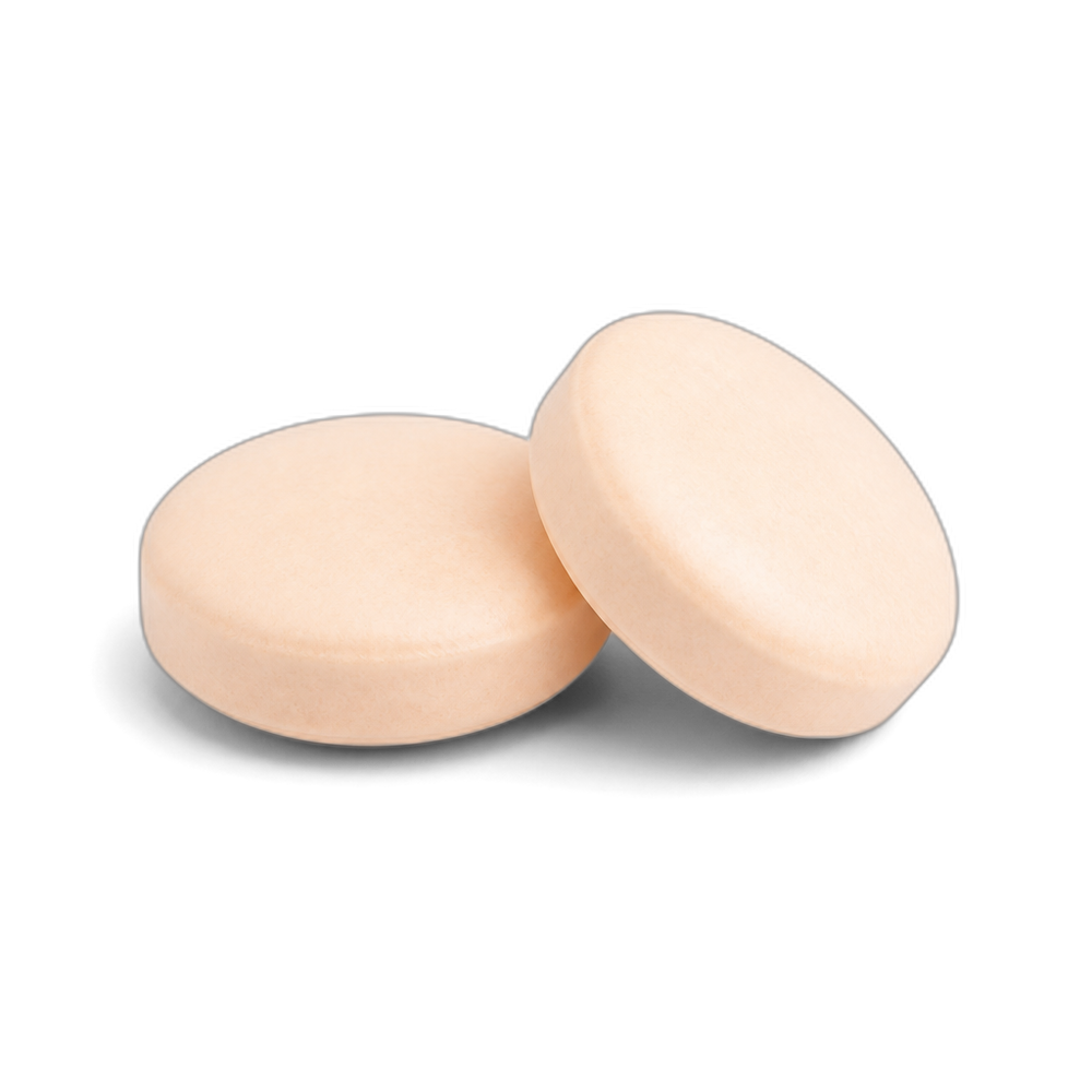 Two pale peach round chewable tablets